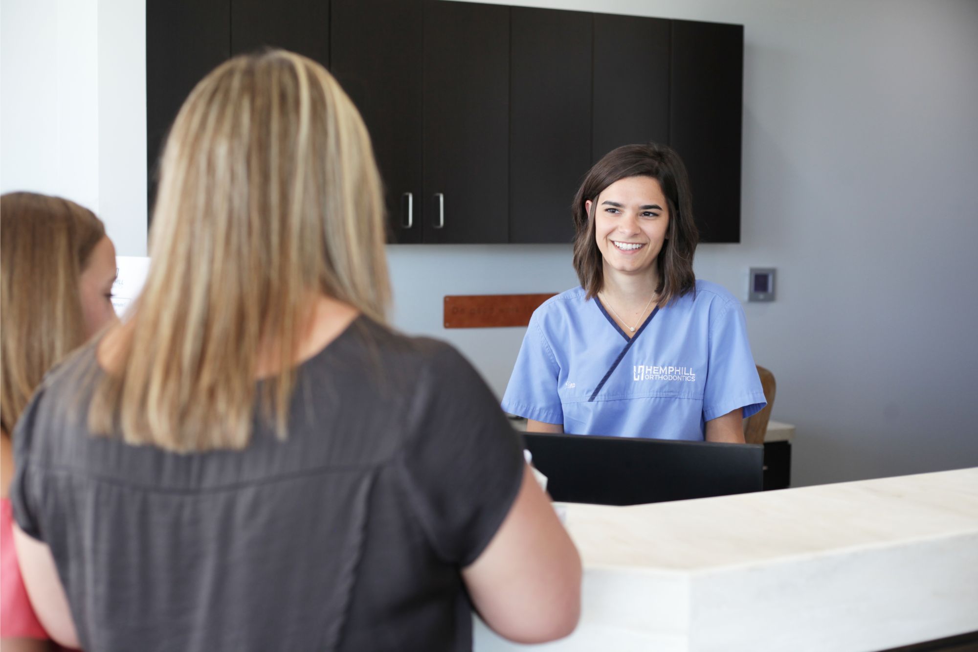 hempill ortho team member helping patient